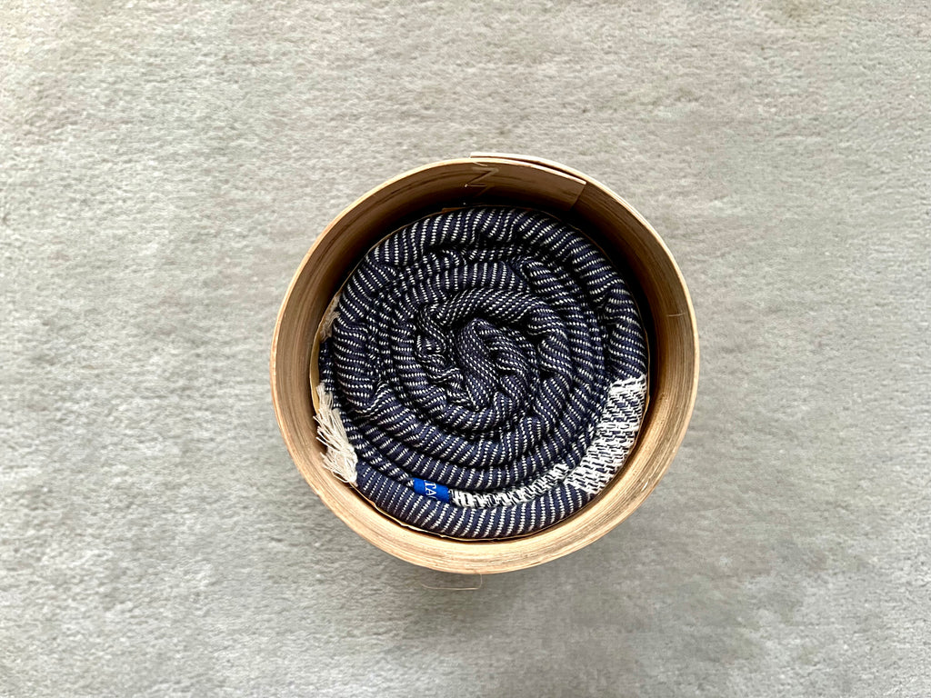 Le Grand Krama Doux Bleu Marine dans son écrin en écorce de palmier