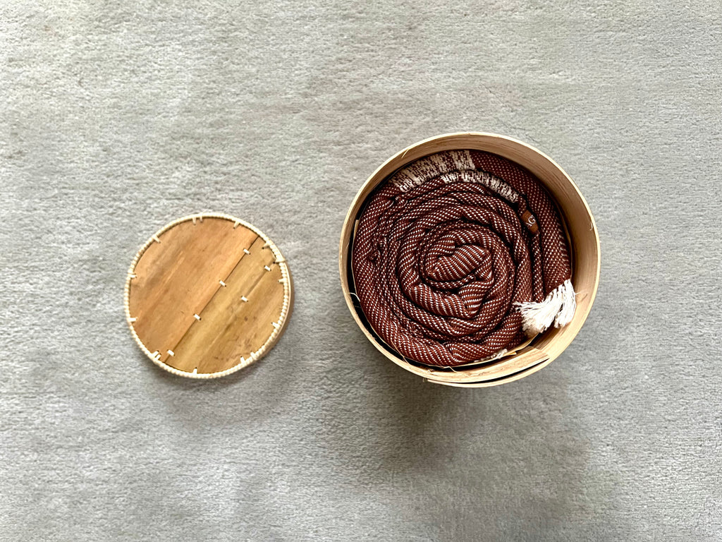 Le Grand Krama Doux Marron dans son écrin en écorce de palmier