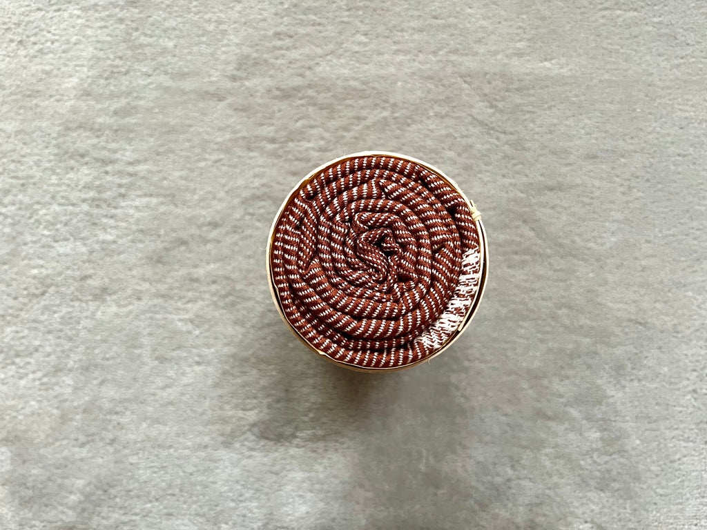 Le Krama Doux Marron dans son écrin en écorce de palmier